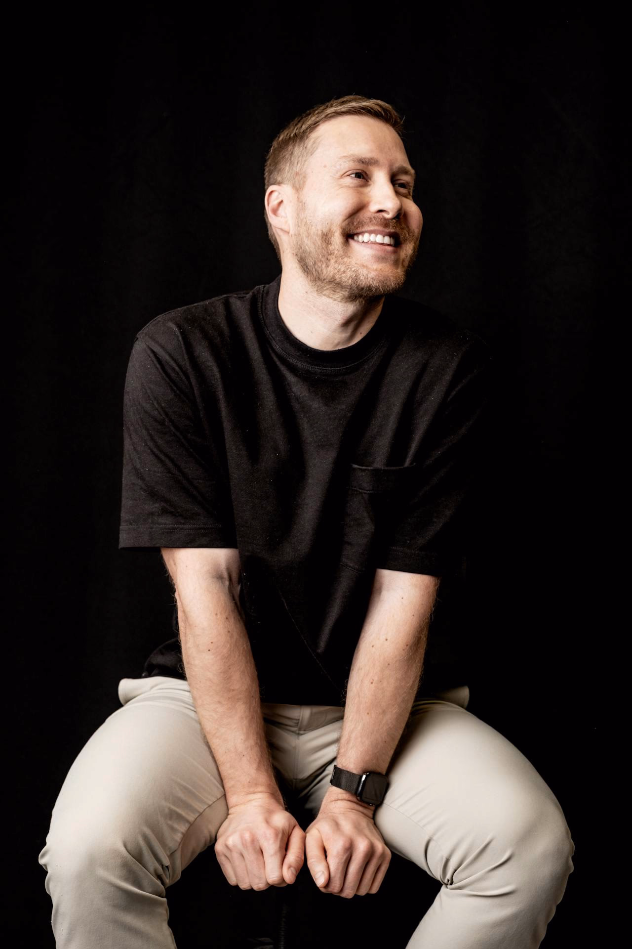 a man with black t shirt smiling